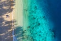 Aerial view of a people couple on the beach. Vacation and adventure. Beach and turquoise water. Top view from drone at beach, azur