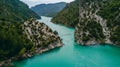 Aerial view of people crossing a bridge in the river on summer in Catalan Pyrennes. Congost de Montrebei La Noguera, Catalonia,