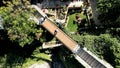 Aerial view of people crossing a narrow wooden bridge over a park on a sunny day in Athens, Greece Royalty Free Stock Photo