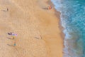 Aerial view of people enjoying a sunny day on a beach in Nazare in Portugal
