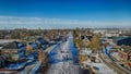 Aerial view of people on a frozen river in a small town in winter Royalty Free Stock Photo