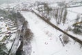 Aerial view of people playing on sledges during a snowstorm (Ebbw Vale, Wales