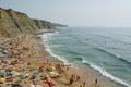 People relaxing On ocean portugal beach