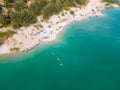 aerial view of people swimming sunbathing resting at sandy beach