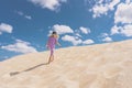 Aerial view photo - a lonely girl walks on the sandy desert. Royalty Free Stock Photo