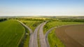 Aerial view photo of the road amid field. Royalty Free Stock Photo