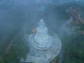 .aerial view Mist blows over the Phuket Big Buddha in colorful sunrise