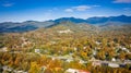 Aerial view picturesque Asheville neighborhood during the Fall with colors starting to show and Sun Rays