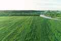 Aerial view of picturesque landscape with green fields and forest and river. Royalty Free Stock Photo