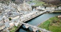 Aerial view of picturesque village of Estaing with medieval castle and gothique arched bridge across Lot river, Aveyron