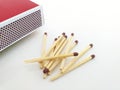 Aerial view of Piles of brown matchstick isolated on white with Matchbox. Wooden rods with a flammable head used to light a fire