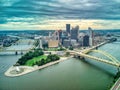 Aerial view of Pittsburgh downtown skyline over the bridge on under dramatic sky