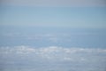 Aerial view from plane window with blue sky and white clouds Royalty Free Stock Photo