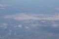 Aerial view from plane window with blue sky and white clouds Royalty Free Stock Photo