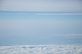 Aerial view from plane window with blue sky and white clouds Royalty Free Stock Photo