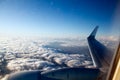 Aerial view with plane wing above clouds Royalty Free Stock Photo