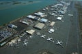 Aerial view of planes, helicopters, and cars parked by buildings Royalty Free Stock Photo