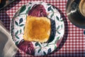 Aerial view of a plate with a toast spread with peach jam Royalty Free Stock Photo