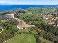 Aerial view on Playa de Poo during low tide near Llanes, Green coast of Asturias, North Spain with sandy beaches, cliffs, hidden