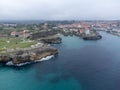 Aerial view on Playa de Toro and Llanes old harbour, Green coast of Asturias, North Spain with sandy beaches, cliffs, hidden caves