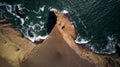 Aerial view of Playa Roja cliffs in Paracas, Peru - brown sand, golden rocks, green water, Royalty Free Stock Photo