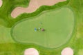 Aerial view of players on a green golf course. Golfer playing on putting green on a summer day Royalty Free Stock Photo