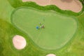 Aerial view of players on a green golf course. Golfer playing on putting green on a summer day Royalty Free Stock Photo