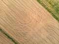 Aerial view of plowed agricultural crop field with the traces of vehicles left during the processing of the field Royalty Free Stock Photo