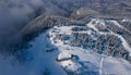 Aerial view of Poiana Brasov ski resort from Postavaru Mountains in Romania. Royalty Free Stock Photo