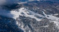 Aerial view of Poiana Brasov ski resort from Postavaru Mountains in Romania. Royalty Free Stock Photo