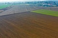 Aerial view on polish rural area with old tractor while plowing the soil on wheat field before sowing the seeds Royalty Free Stock Photo