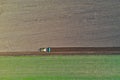 Aerial view on polish rural area with old tractor while plowing the soil on wheat field before sowing the seeds Royalty Free Stock Photo