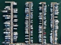 Aerial view of pontoons full of boats and sailboats in the marina.