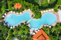 Aerial view at the pool and palm trees. A place for rest and relaxation. Beach umbrellas. Beach club for relaxation in Asia. Bali Royalty Free Stock Photo