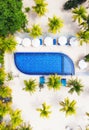Aerial view at the pool and palm trees. Place for rest and relaxation. Beach umbrellas. Beach club for relaxation. Bali island, In