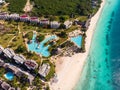 Aerial view of pool, umbrellas, sandy beach with green Palm trees. Coast of Indian ocean at sunset in summer. Zanzibar Royalty Free Stock Photo