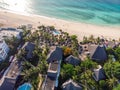 Aerial view of pool, umbrellas, sandy beach with green Palm trees. Coast of Indian ocean at sunset in summer. Zanzibar Royalty Free Stock Photo