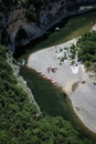 Aerial view of a populated bench of the river with boats near Ardeche Gorges