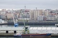 Aerial view of the port of A CoruÃÂ±a with freighter in the foreground and the fish market in second with the city in the