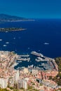 Aerial view of port Hercules of Monaco at sunset, Monte-Carlo, huge cruise ship is moored in marina, view of city life