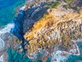Aerial view of Porto Ferro tower surrounded by blue water Royalty Free Stock Photo