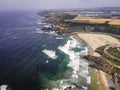 Aerial view of Praia de Odeceixe with people on the beach in summertime with Atlantic Ocean rough sea in background, Odeceixe, Royalty Free Stock Photo