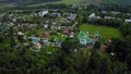 Aerial view on private country side village houses on land plots among river, green forest, fields