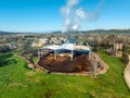 Aerial view of a processing plant emitting smoke, surrounded by fields Royalty Free Stock Photo