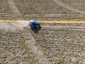 Aerial view of pumpkin harvest with a tractor, Modern pumpkin seed farming