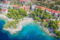 Aerial view of Punta Rata beach with boats and azure sea in Brela, Croatia, Dalmatia, Croatian azure coast