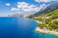 Aerial view of Punta Rata beach with boats and azure sea in Brela, Croatia, Dalmatia, Croatian azure coast