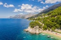 Aerial view of Punta Rata beach with boats and azure sea in Brela, Croatia, Dalmatia, Croatian azure coast