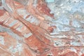 Aerial view of the quarry, beautiful orange patterns and overhanging rocks in a copper-magnesium quarry