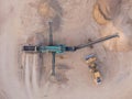 Aerial view of a quarry with conveyor belt and wheel loader - stones and sands for construction - top view , open pit mine, extrac